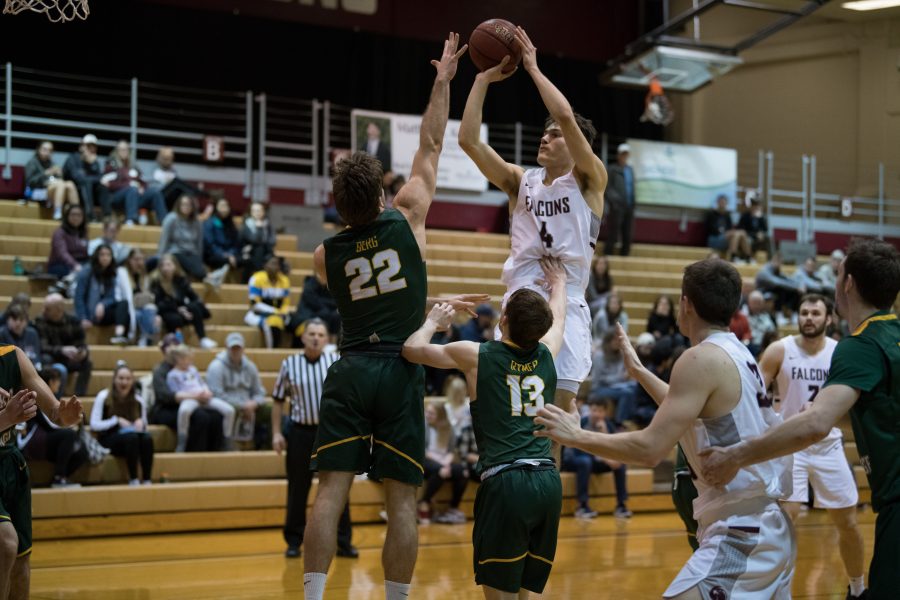 Sophomore Harry Gavell makes a shot as he is being pushed by the opposing team.

Alison Meharg | The Falcon
