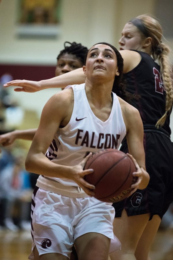 Kaprice Boston, sophomore, brings the ball to the away side of the court with her eye on the basket.

Alison Meharg | The Falcon