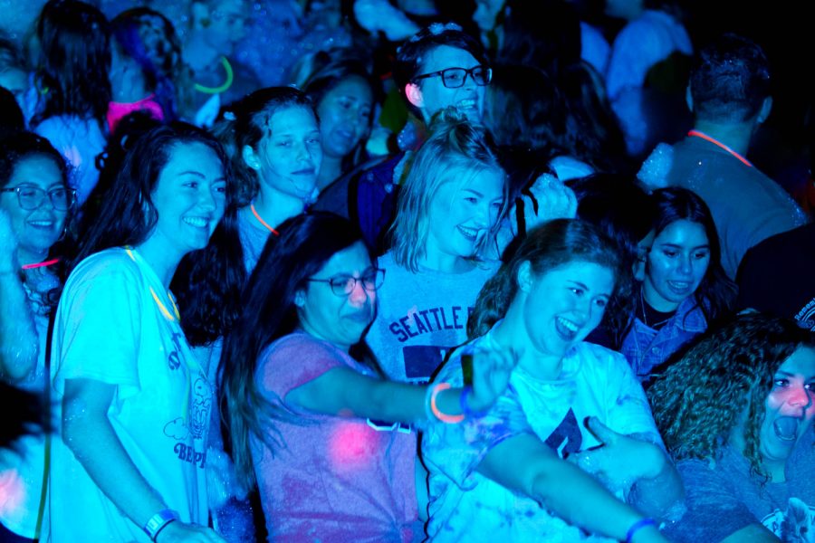 Girls in a crowd smile and dance