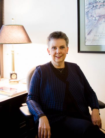 A woman sitting in a chair smiling