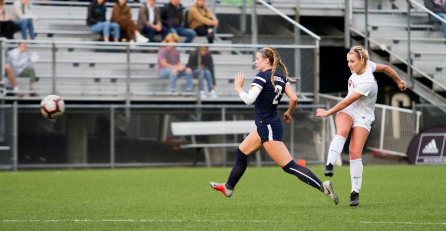 A girl kicks a soccer ball