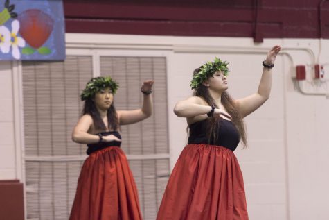 two women dance in lu'au clothing