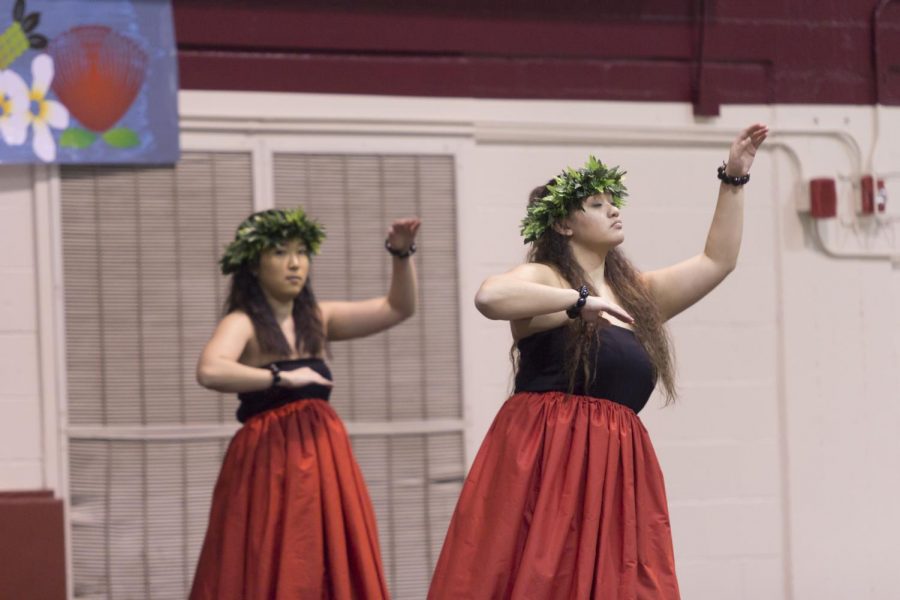 two women dance in luau clothing