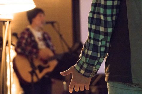 A persons hand lifted in worship.