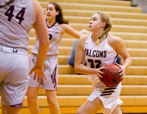 A woman runs with a basketball