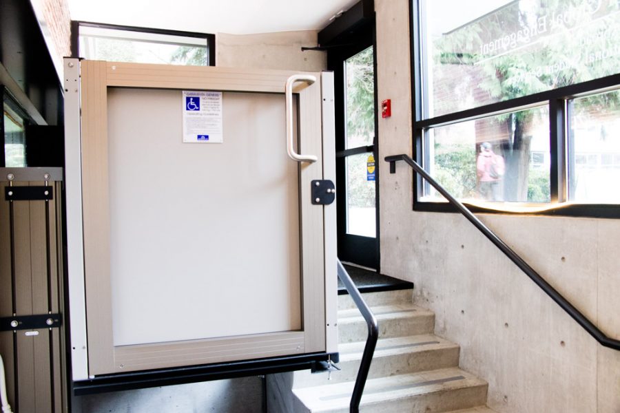 A wheelchair lift next to a set of stairs