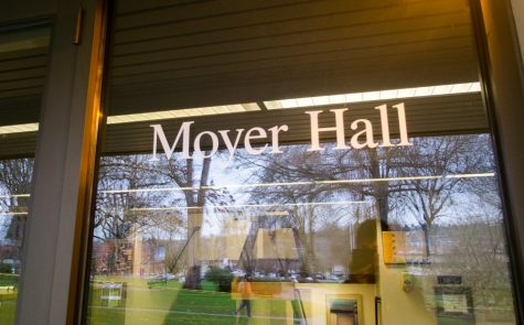 a sign on the front windows of a dormitory which reads "moyer hall"