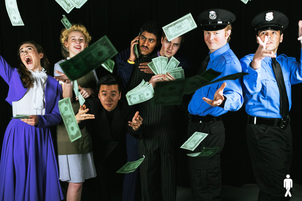 A group of actors in costume pose for a photo