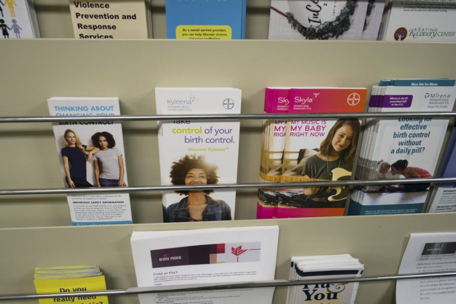 brochures in a rack, with one reading take control of your birth control