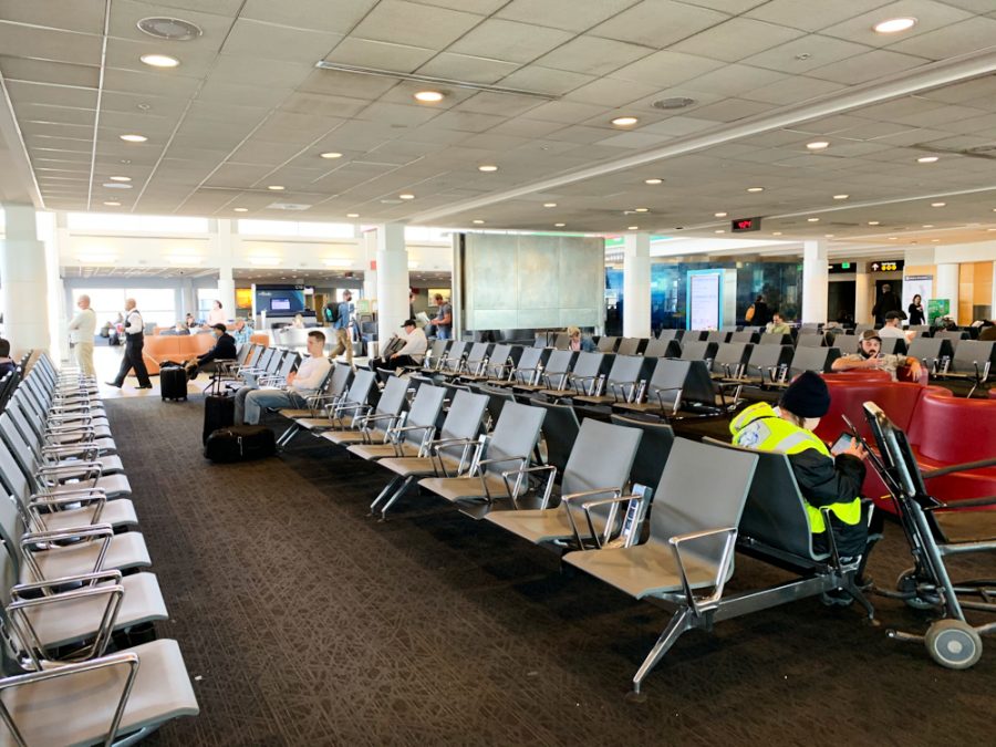An airport gate with rows of empty seats