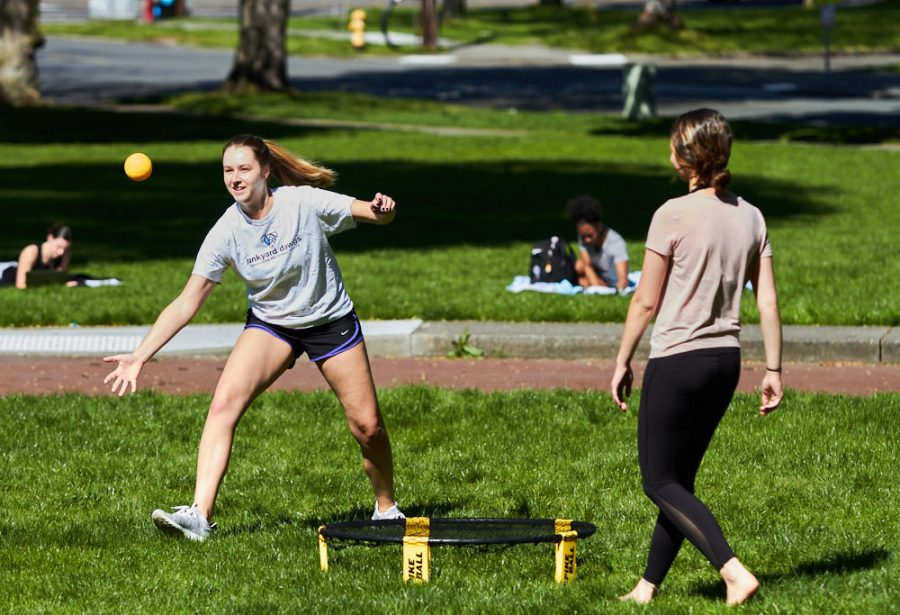 two women play a game of spikeball
