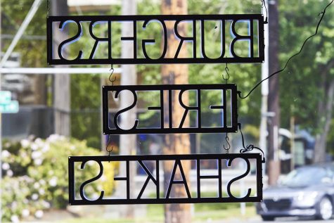 a neon sign with the words "burgers, fries, shakes."