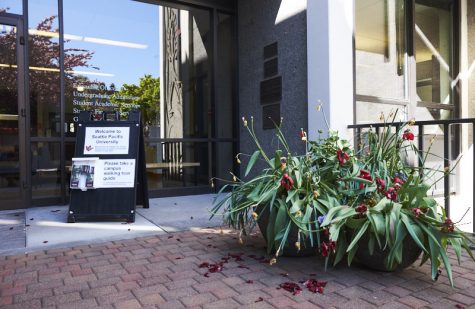 a sign with walking tour maps outside of a college admissions office