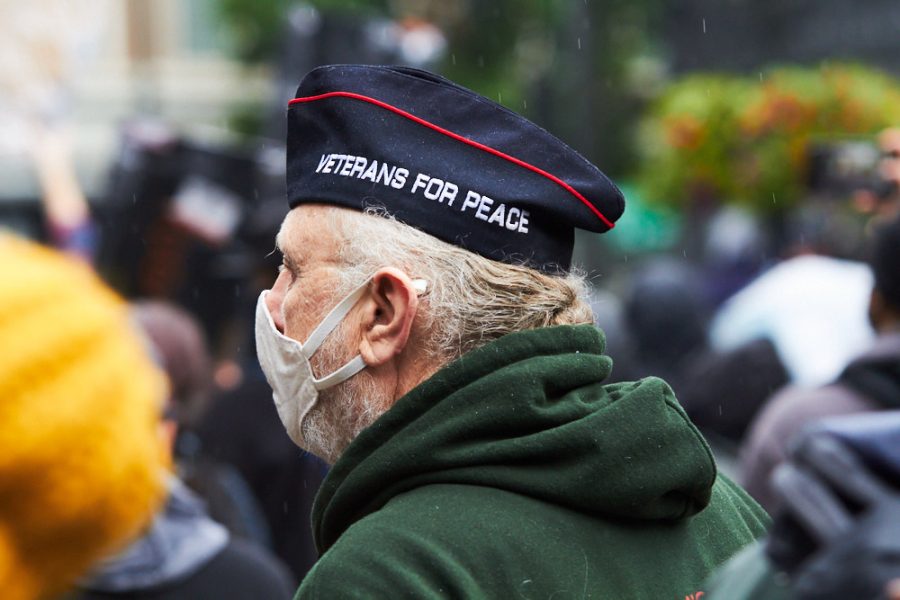 a man wearing a hat that says veterans for peace