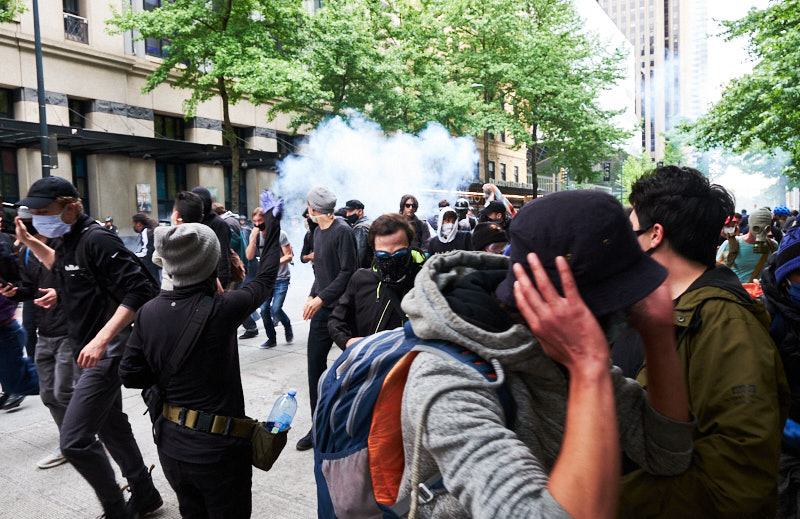 Protestors flee from flash bang grenades