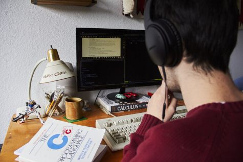 A man writes code on a computer