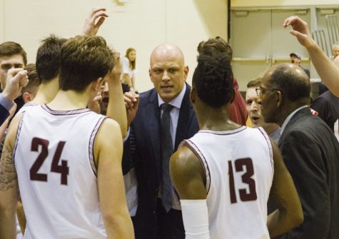 A basketball coach talks to basketball players