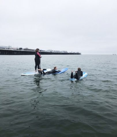 three women paddle boarding