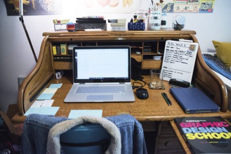 a photo of a desk with a laptop on it