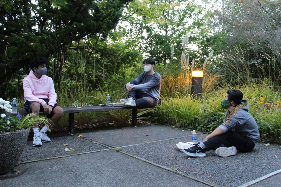 Outside Weter Hall, (left to right) David Kumar, Joo Hwan Lee, and Joshua Hyodo social distance while they have dinner, as they are unable to eat together in Gwinn Commons due to COVID guidelines.