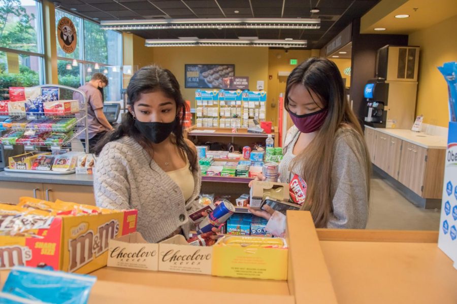 Tianna Flores and Maille Duque explore the options at the C store near Martin Square, the main spot on campus for grab and go snacks.