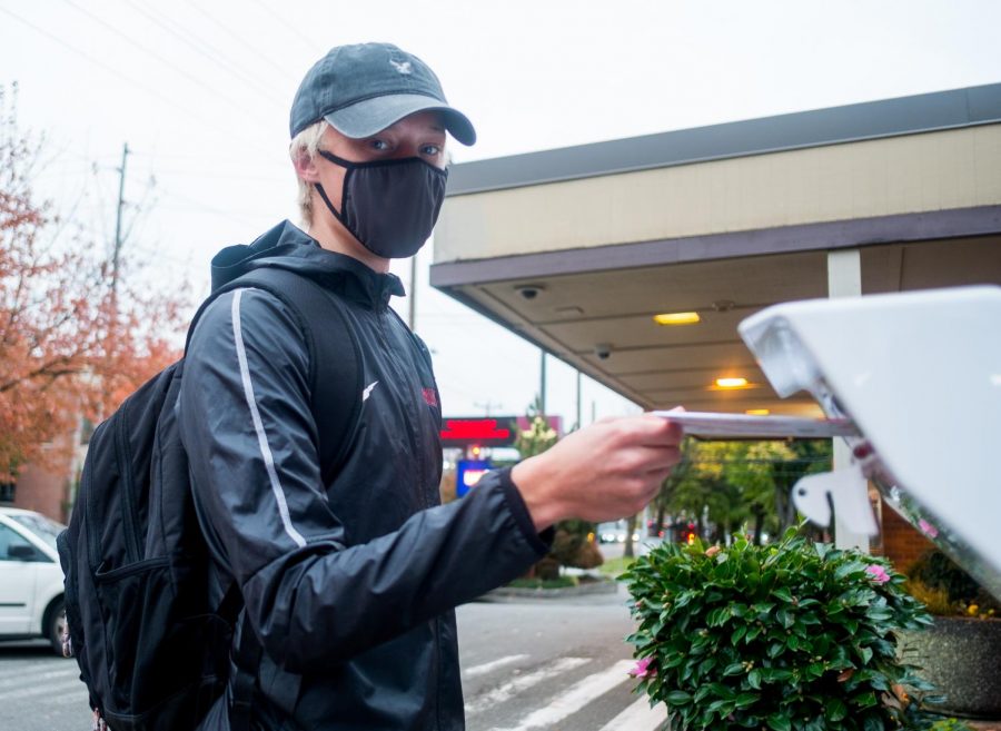 800m track runner J.R. Hentges submitting his ballot into the ballot box next to the SPU Book Store.