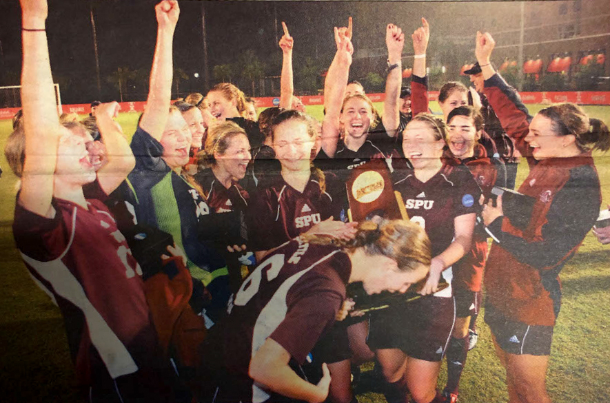 The members of the Falcons championship winning Womens soccer team in 2008 celebrate in the rain with their trophy after defeating West Florida in double overtime.