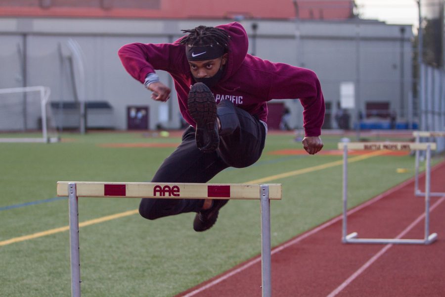 David Njeri practices form as he attacks his 4th hurdle in a drill.