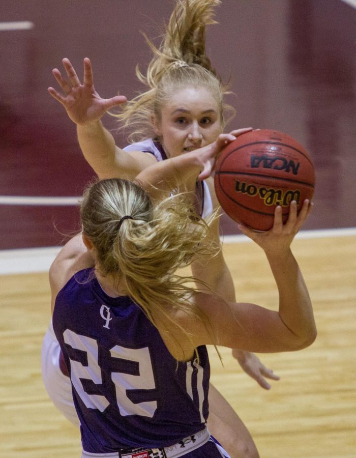 Rachel Berg forces College of Idaho player to either pass the ball or lose it.