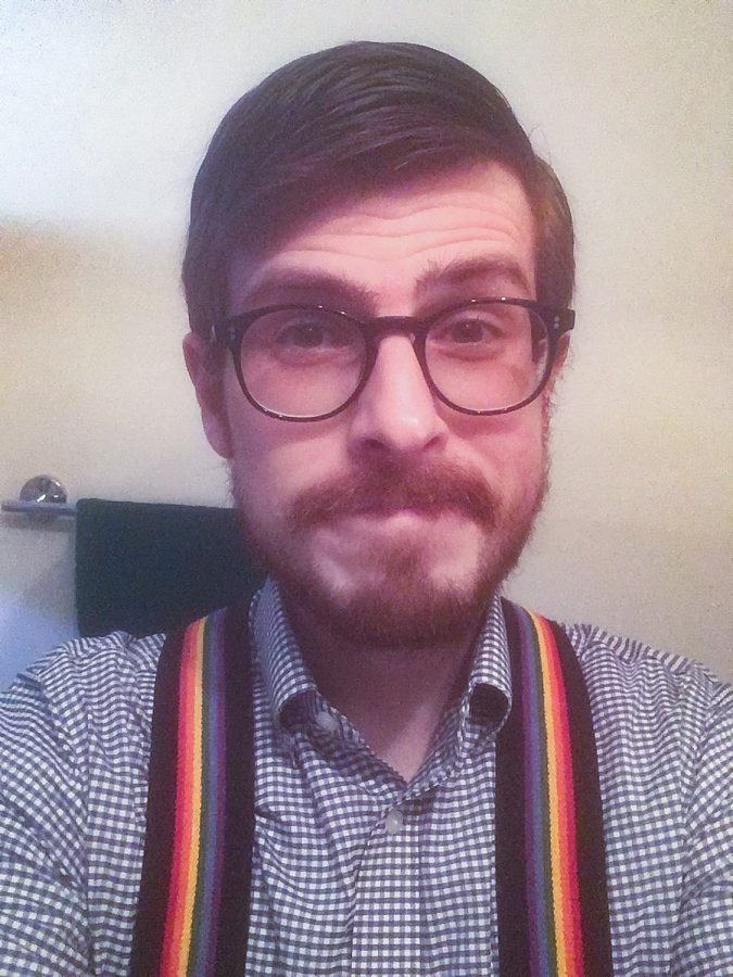 Communication professor Dr. Matthew Bellinger dresses up in rainbow suspenders. Bellinger wore these suspenders to his classes on Monday in support of the LGBTQ community after the board of trustees decided to uphold the statement on human sexuality.