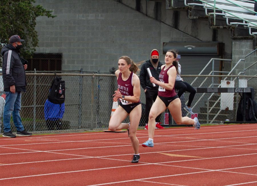 Renick Meyer hands off the baton to Julia Stepper during the 4 by 100 meter relay against Seattle University.