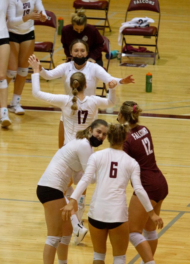 Players on the court cheer after a massive play (front to back, Maddie Batiste, Lindsay Lambert, Lindsay Rosenthal, Ashley Antoniak, Paige Dawson).