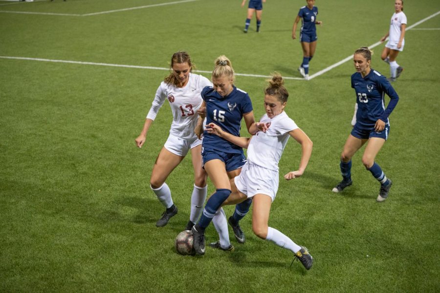 Claire Neder and Sophia Chilczuk fight for possession with Western Washingtons Katie Watt.