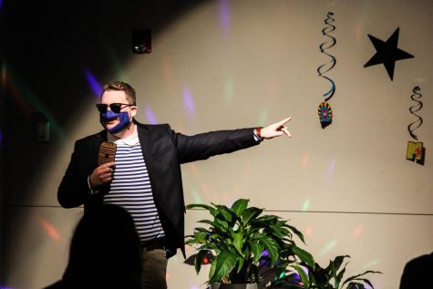 Emerson Hall resident Tyler Gagnon uses a fake microphone and see-through mask for his lip-sync rendition of Rick Astleys Never Going to Give You Up. (Gabrialla Cockerell)