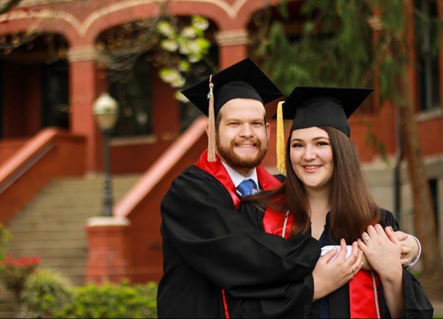 Cambria Judd with her husband Nathan Judd outside of Peterson Hall posing for graduation photos. (Courtesy of Cambria Judd)