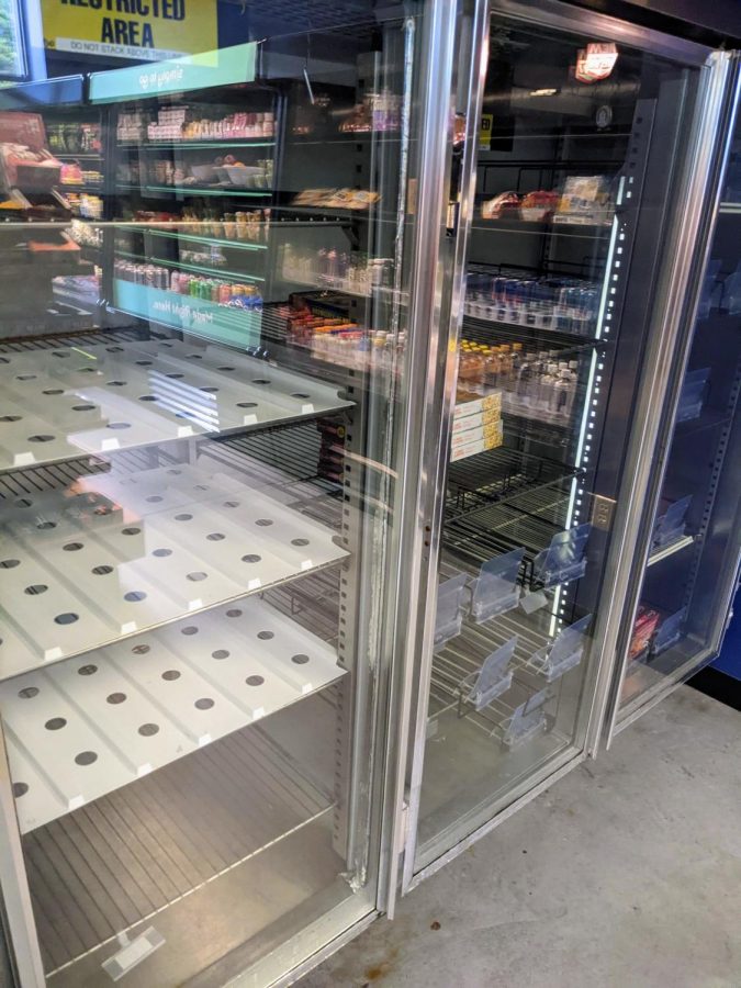 The shelves of the C-Store freezers empty.