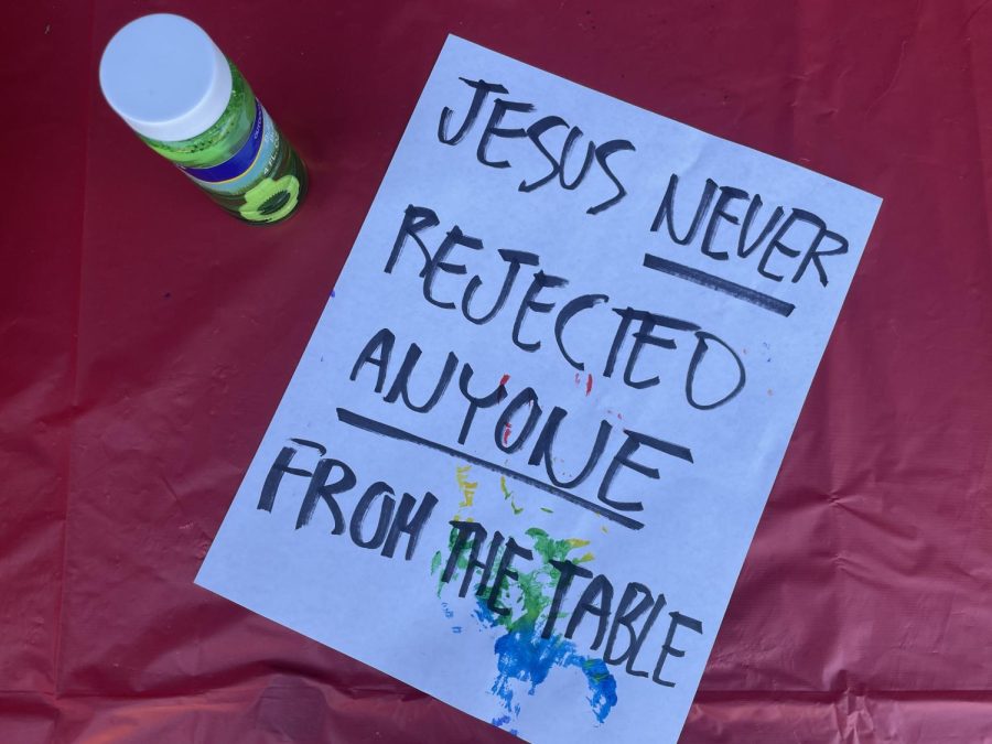 A sign reading “Jesus never rejected anyone from the table” is pictured at the October 11 event.