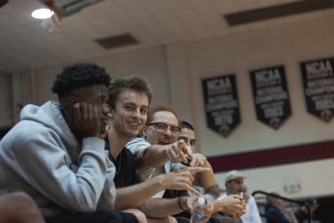 From left to right, Jeff Gordon, Evan Carpenter, Darius Holmes, and Kainoa Lee cheer during a SPU womens volleyball game on Sept. 29, 2022.