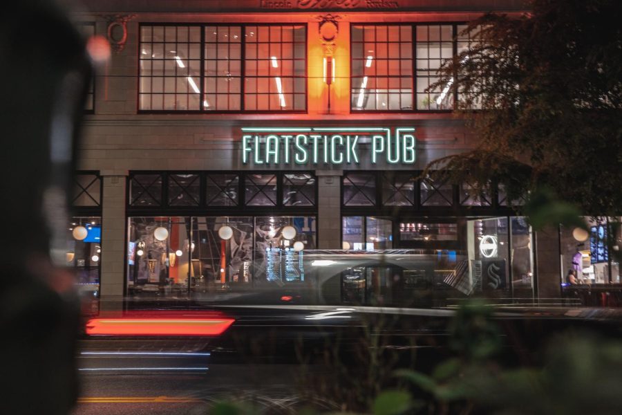 A car drives past the Flatstick Pub on Westlake avenue in South Lake Union on Thursday night, Oct. 6, 2022.