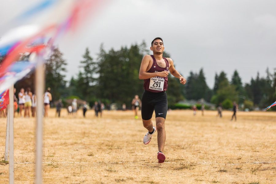 Gabe Enderson crosses the finish line at the Puget Sound Invitational cross country meet in Tacoma, Wash., on Sept. 6, 2022.