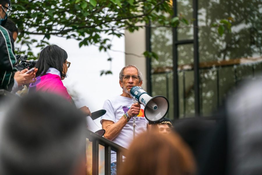 Dr. Kevin Nuehauser speaks at a demonstration 