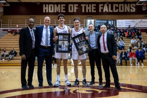 Seattle Pacific Seniors Kelton Samore (33) and S Zack Paulsen (1) pose for a photo with their coaches ahead of Seattle Pacific University’s game against Alaska Fairbanks at Royal Brougham Pavilion in Seattle, Wash., Saturday, Feb. 25, 2023. SPU Won 60-51.