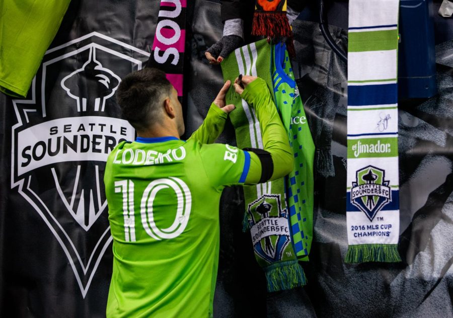 Seattle Sounders midfielder Nicolás Lodeiro (10) signs a scarf for a fan after the Major League Soccer match between the Seattle Sounders and the Colorado Rapids at Lumen Field on Sunday, Feb. 26, 2023, in Seattle, Washington. The Sounders won 4-0.