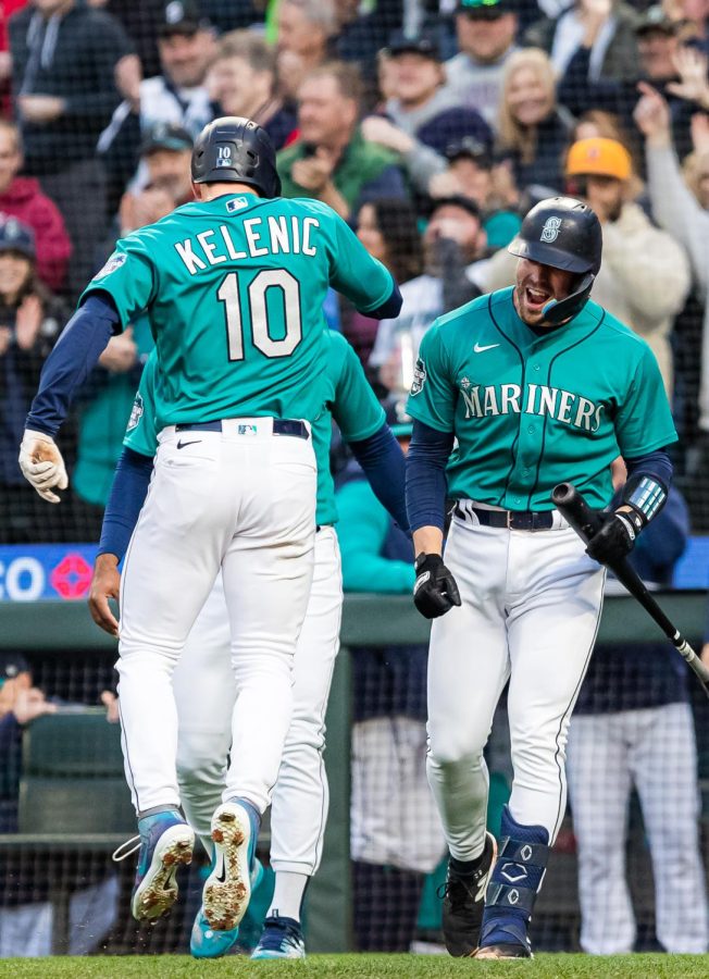 Seattle Mariners left fielder Jarred Kelenic (10) celebrates with Seattle Mariners first baseman Ty France (23) after hitting a home run during the second inning of a baseball game Friday, April 14, 2023, in Seattle. The Mariners won 5-3.