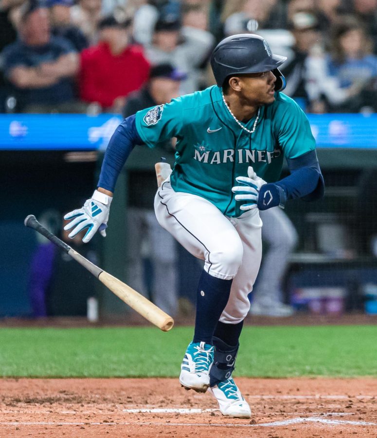 Seattle Mariners center fielder Julio Rodriguez (44) runs to first after hitting a ball to center field during the fourth inning of a baseball game Friday, April 14, 2023, in Seattle. The Mariners won 5-3.