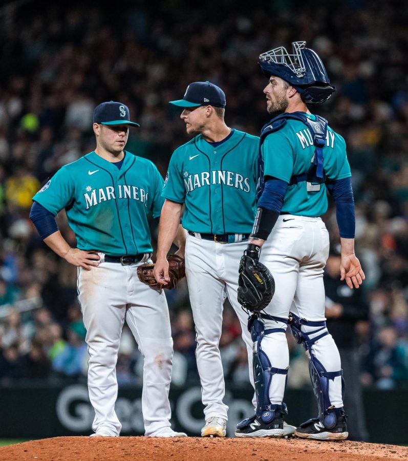 From right to left Seattle Mariners catcher Tom Murphy (23), Seattle Mariners relief pitcher Trevor Gott (30) and Seattle Mariners first baseman Ty France (23) gather at the mound during a baseball game Friday, April 14, 2023, in Seattle. The Mariners won 5-3.