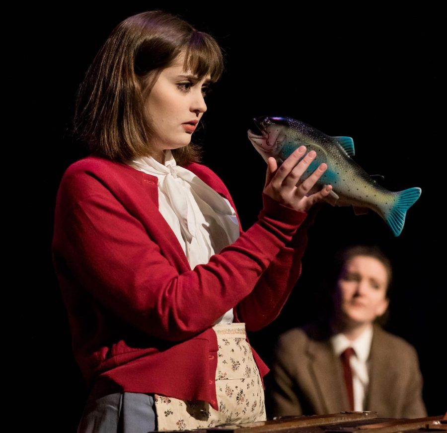 Hayley Philpot holds a prop fish during a performance.