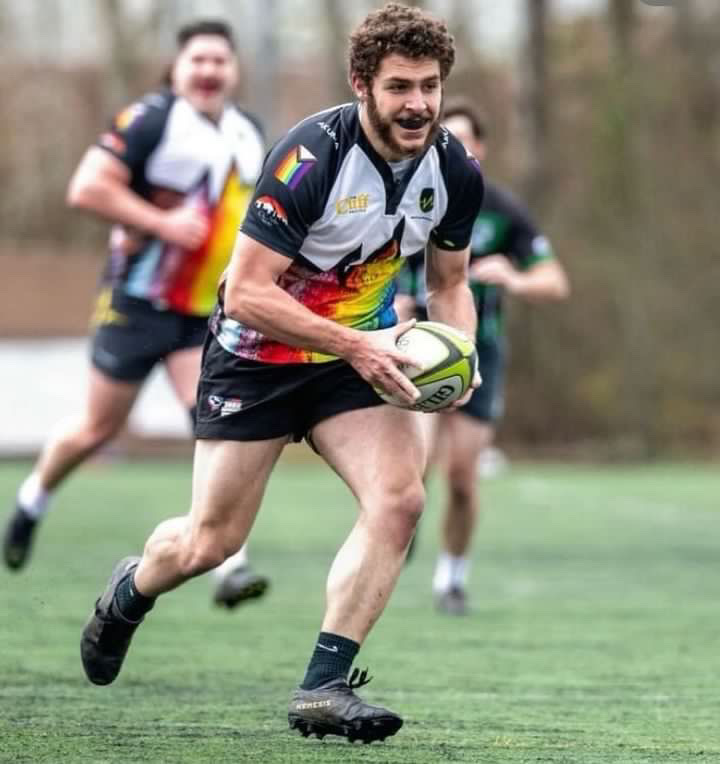 Jared Hubbell runs with the ball during a rugby match.