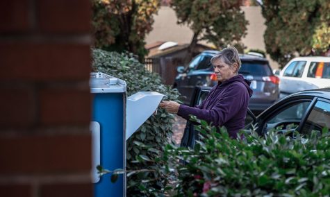 A women places her ballot in a dropbox outside of the Queen Anne U.S. Bank during the 2022 elections on Tuesday, Nov. 8, 2022.
