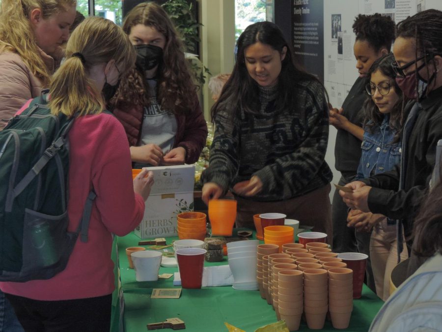 SPU students plant seeds in Weter Hall during the Earth Day Celebration hosted by Upperclass & Commuter Ministries and the Sustainability Club on Thursday, April 20, 2023.